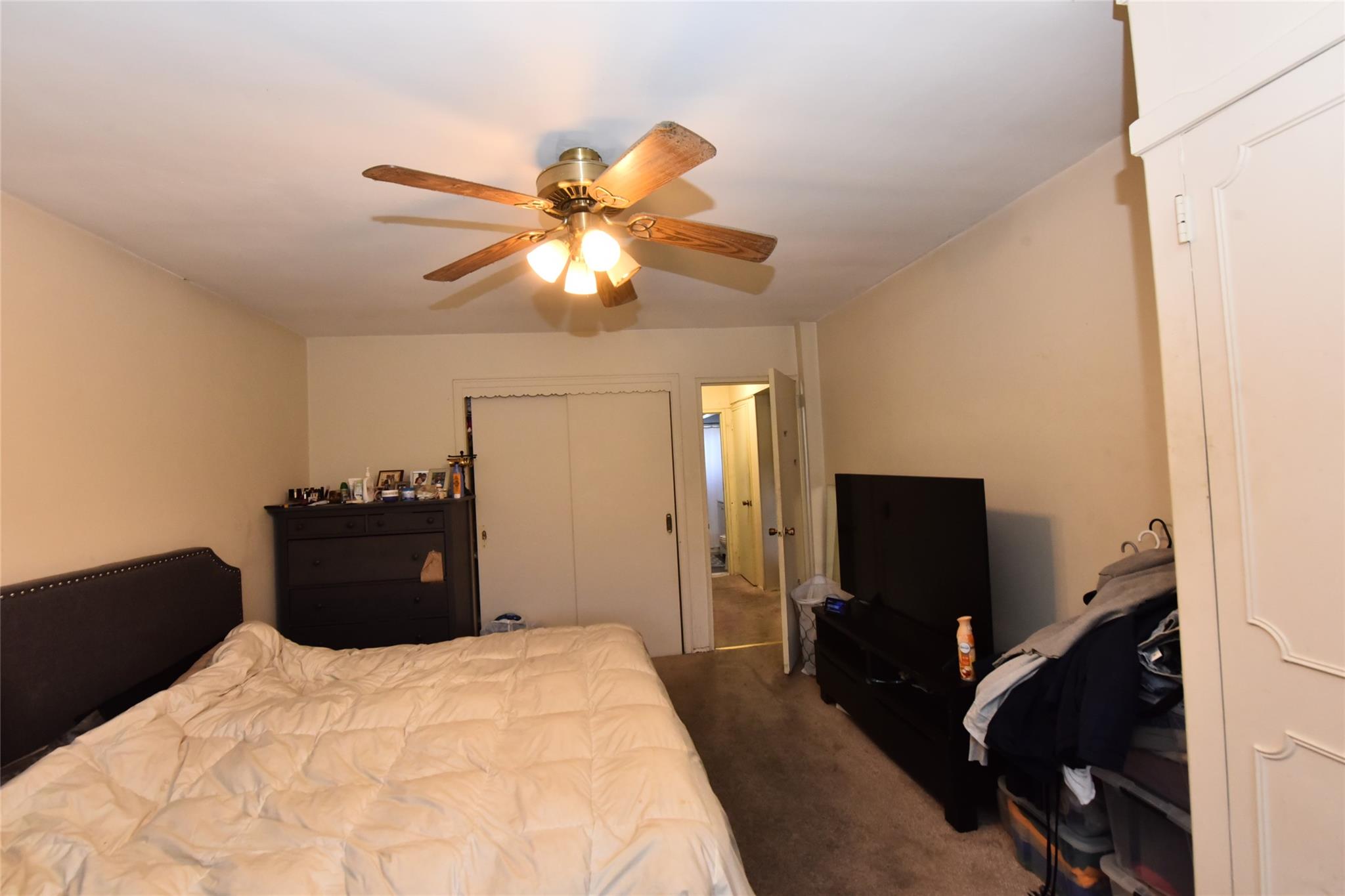 202-35 Foothill Avenue, Unit A78 Queens, NY 11423 - Photo 8 of 12 a bedroom with a bed and a flat screen tv