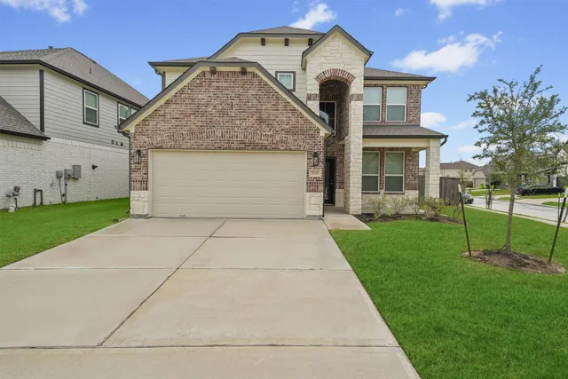 a front view of a house with a yard and garage
