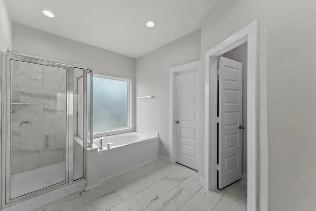 a bathroom with a bathtub and shower