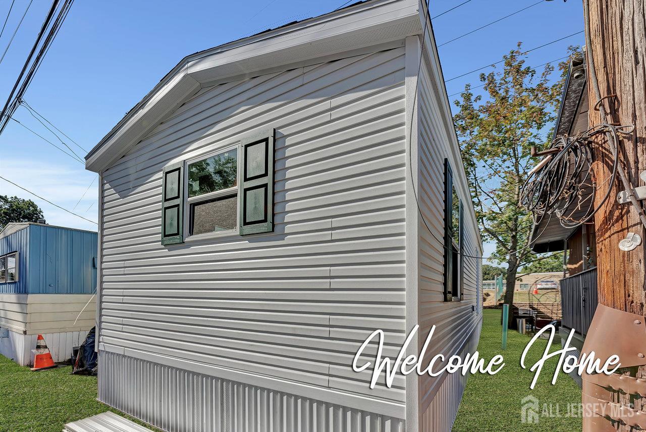 2505 Woodbridge Avenue, Unit 19L Edison, NJ 08817 - Photo 1 of 8 a view of a house with a yard