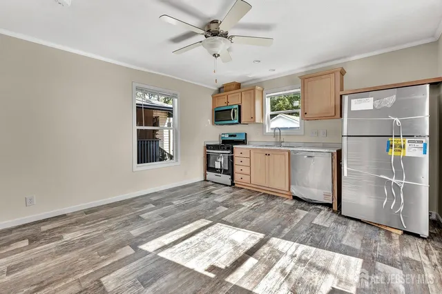 a view of a kitchen with a sink and a refrigerator
