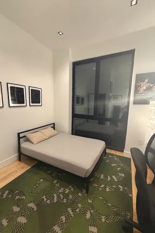 a room with pool table and a rug