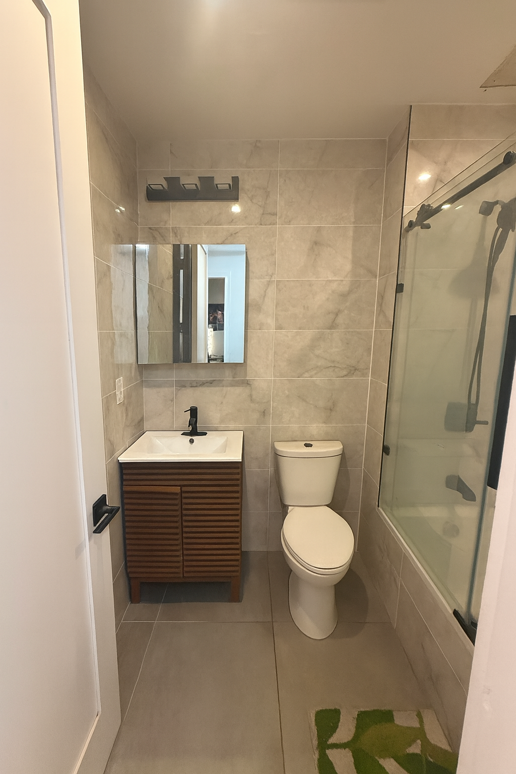 595 3rd Avenue, Unit 1B Brooklyn, NY 11215 - Photo 4 of 8 a bathroom with a sink toilet and shower