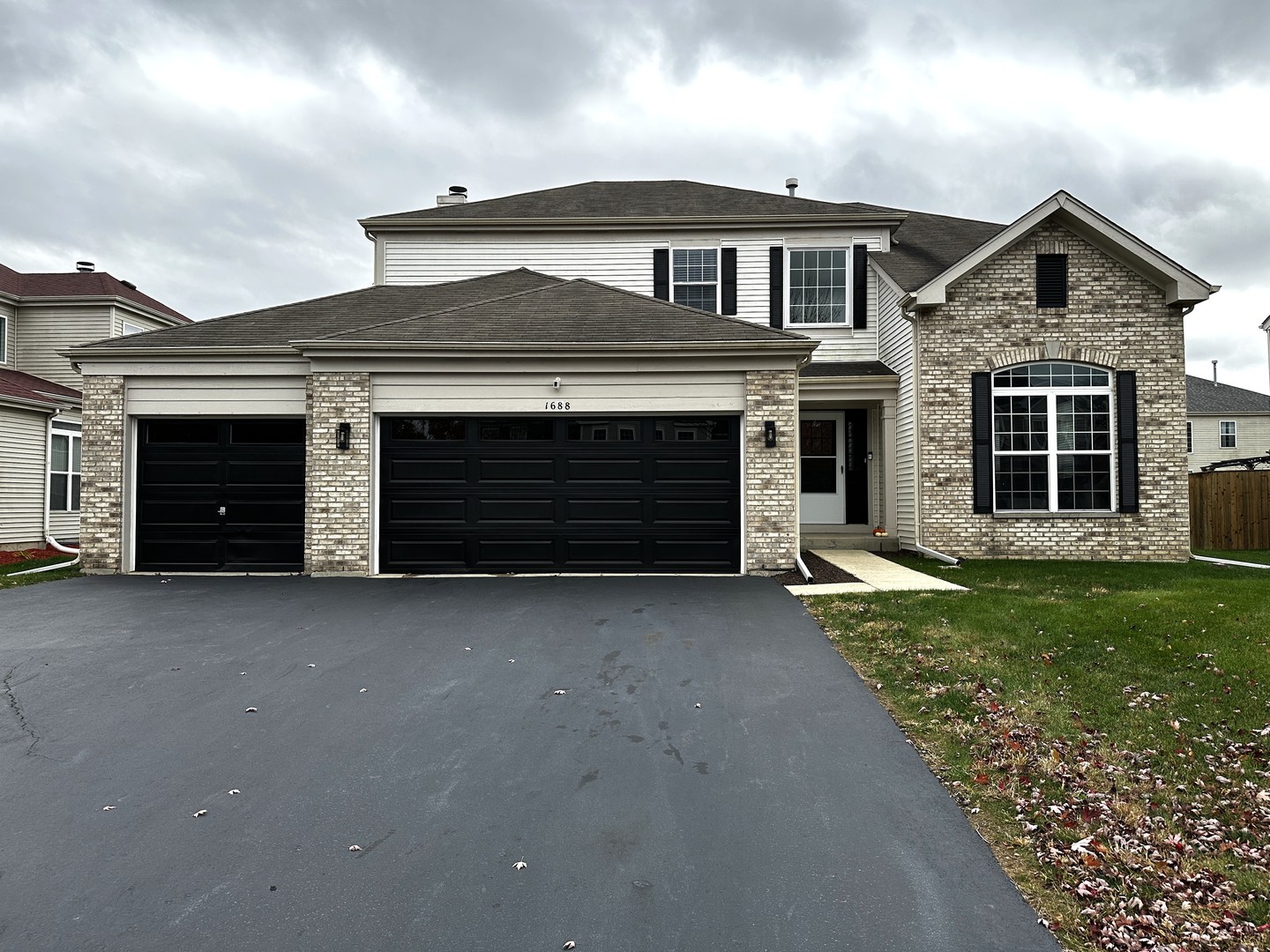 1688 Trails End Lane Bolingbrook, IL 60490 - Photo 1 of 18 a front view of a house with a yard and garage