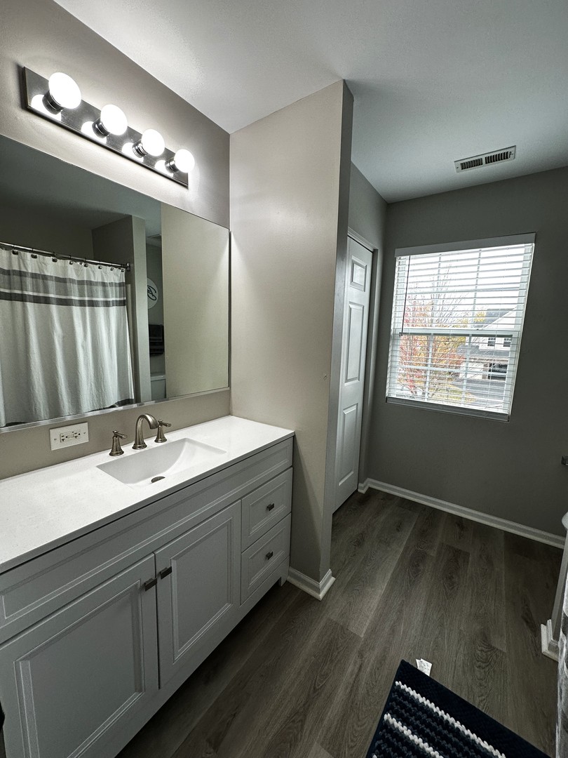 1688 Trails End Lane Bolingbrook, IL 60490 - Photo 13 of 18 a bathroom with double vanity and a mirror