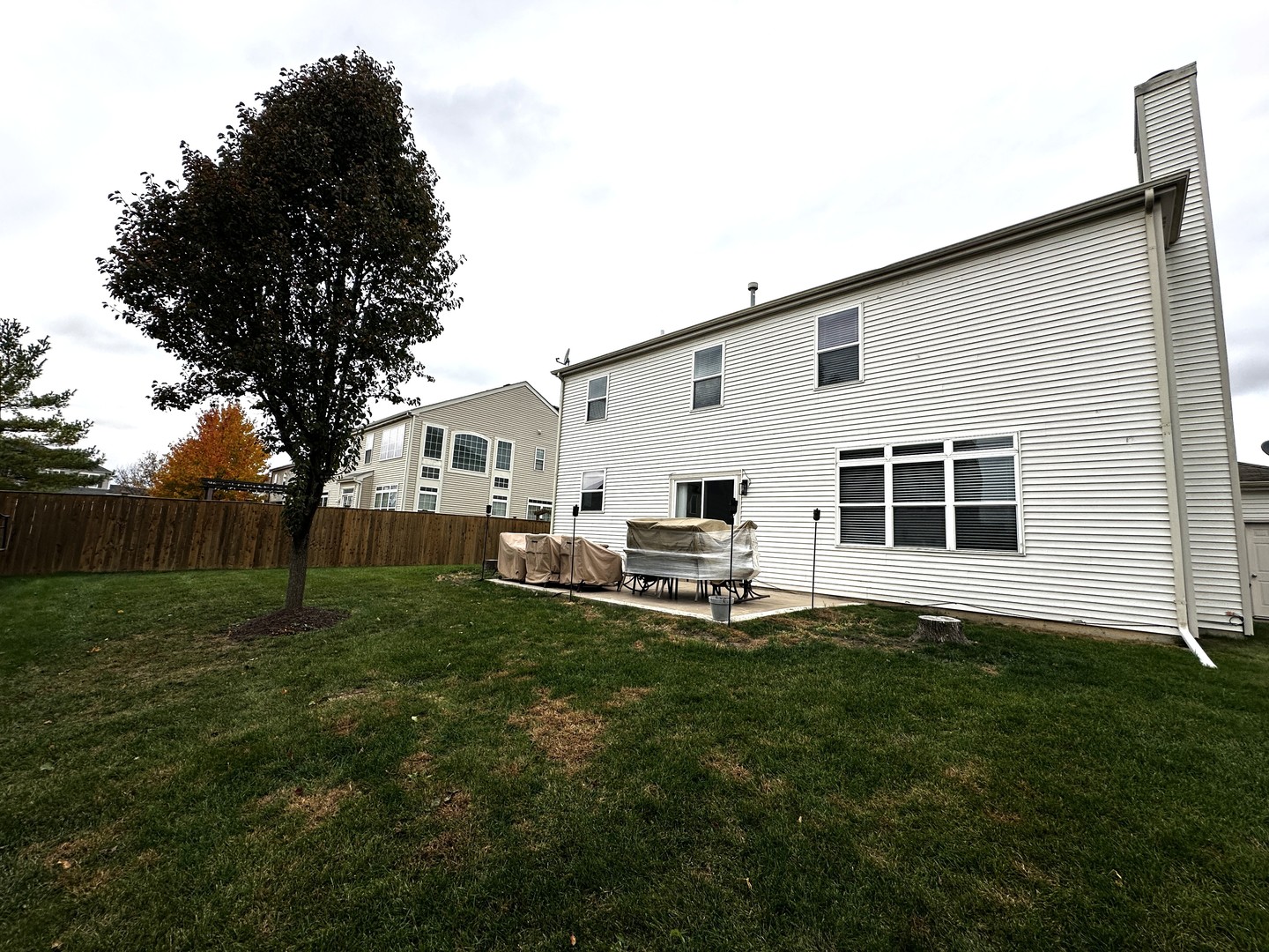 1688 Trails End Lane Bolingbrook, IL 60490 - Photo 17 of 18 a view of a backyard with table and chairs and wooden fence