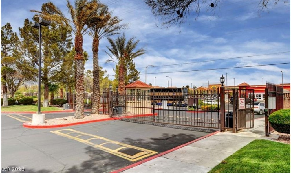 7885 West Flamingo Road, Unit 1008 Las Vegas, NV 89147 - Photo 8 of 29 Secure entry point with iron gates and a guard station ensures privacy and controlled access.