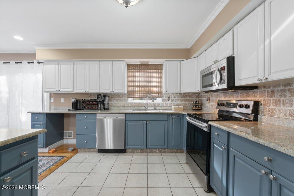 39 Cypress Road Toms River, NJ 08753 - Photo 16 of 52 a kitchen with stainless steel appliances granite countertop a stove sink and cabinets