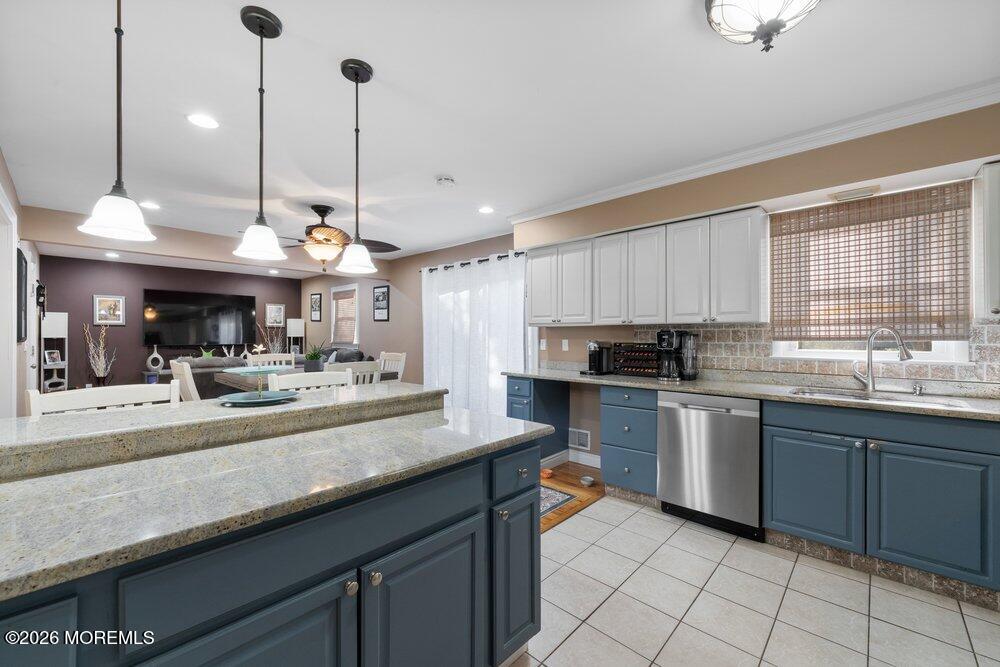 39 Cypress Road Toms River, NJ 08753 - Photo 17 of 52 a kitchen with kitchen island granite countertop a sink a counter top space appliances and cabinets