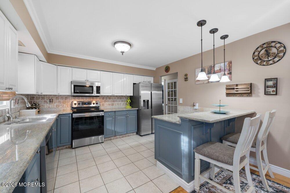 39 Cypress Road Toms River, NJ 08753 - Photo 18 of 52 a kitchen with kitchen island a stove a sink a stove and a refrigerator