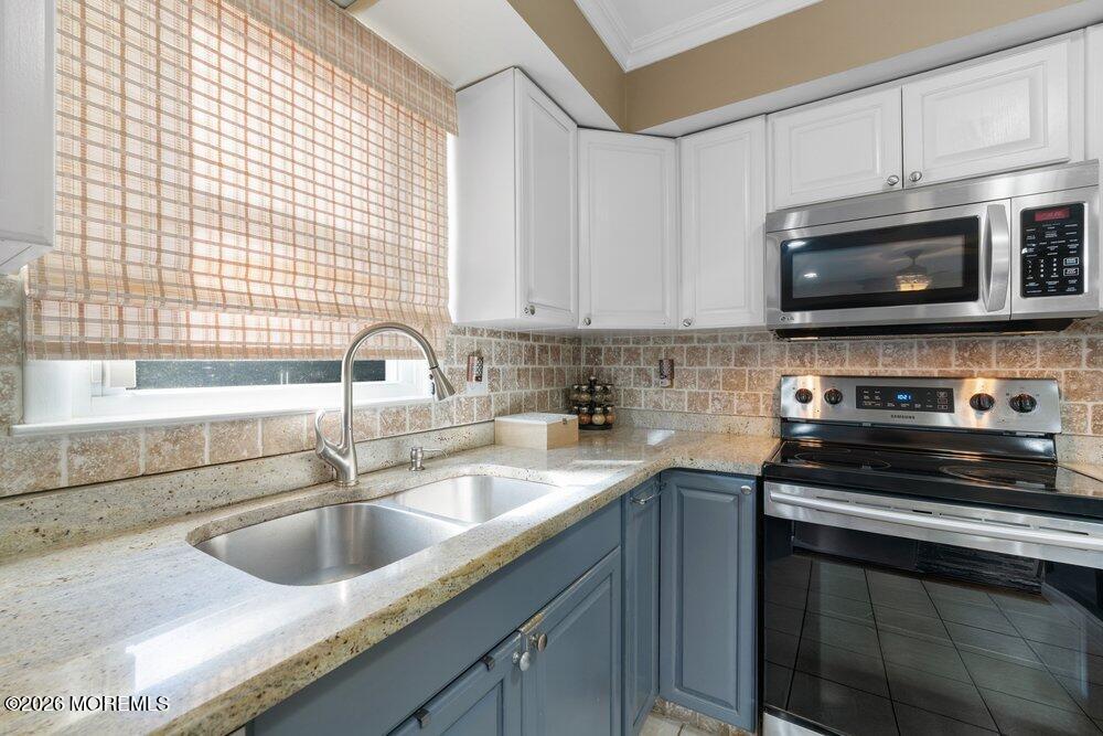 39 Cypress Road Toms River, NJ 08753 - Photo 19 of 52 a kitchen with a sink stove top oven and cabinets