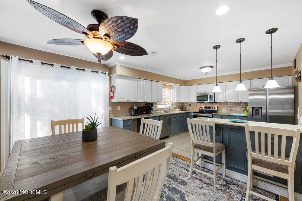 39 Cypress Road Toms River, NJ 08753 - Photo 20 of 52 a kitchen with a table chairs microwave and cabinets
