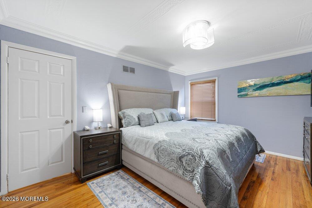 39 Cypress Road Toms River, NJ 08753 - Photo 21 of 52 a bedroom with a bed and a chandelier