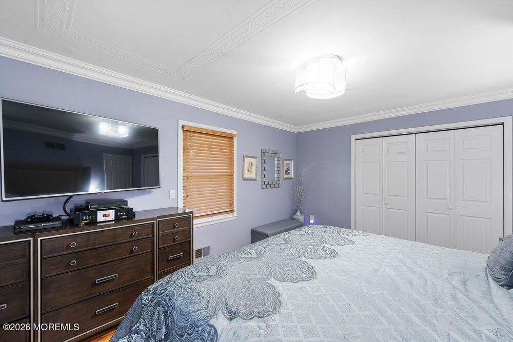 39 Cypress Road Toms River, NJ 08753 - Photo 22 of 52 a bedroom with a bed and a dresser