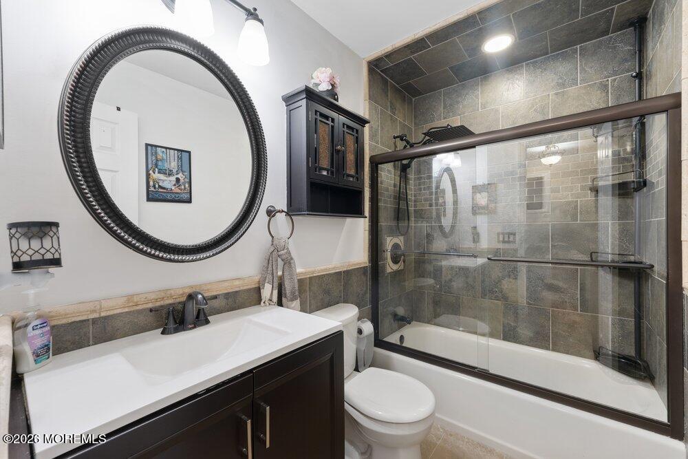 39 Cypress Road Toms River, NJ 08753 - Photo 25 of 52 a bathroom with a sink a toilet and a mirror