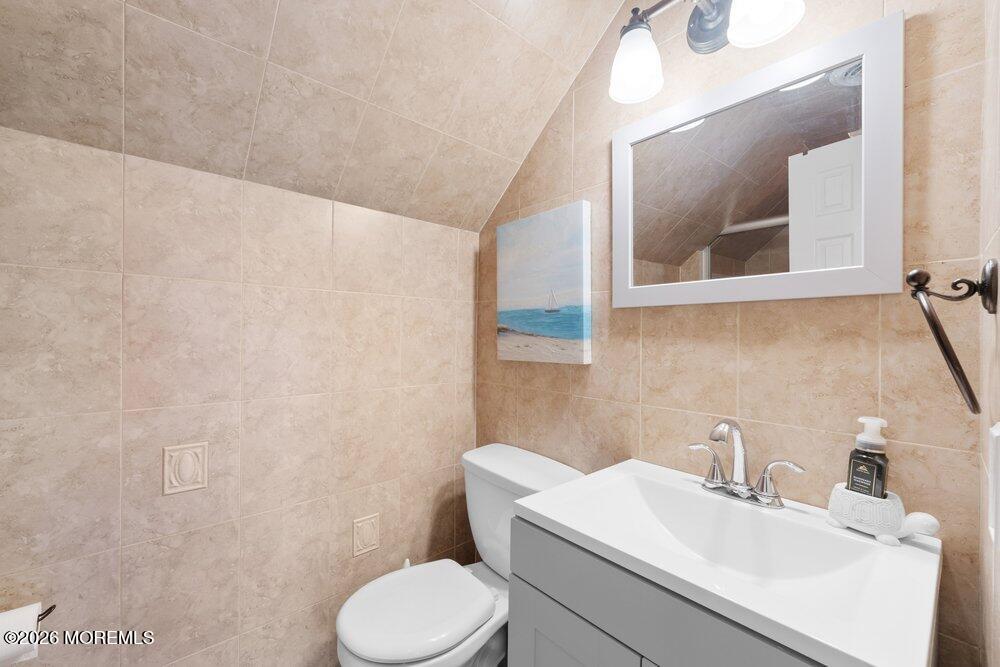 39 Cypress Road Toms River, NJ 08753 - Photo 30 of 52 a bathroom with a toilet a sink and mirror