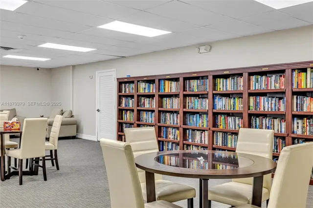a view of a livingroom with furniture and a bookshelf