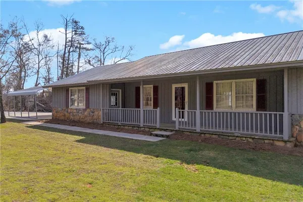 a front view of a house with a yard balcony