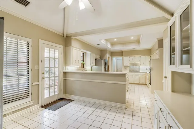 a kitchen with granite countertop a refrigerator and a sink