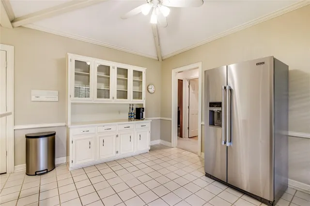 a kitchen with granite countertop a refrigerator and a stove