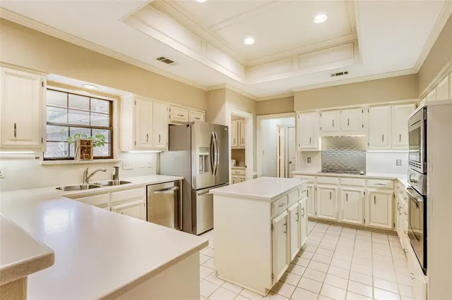 a kitchen with stainless steel appliances granite countertop a sink and cabinets