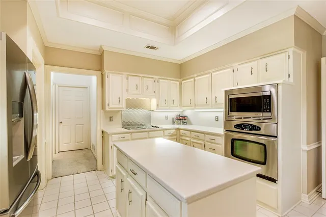 a kitchen with a stove a refrigerator and a sink