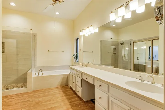 a spacious bathroom with a large tub shower and sink