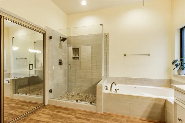 a bathroom with a bathtub and a shower
