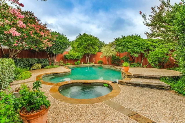 a view of a swimming pool with a yard