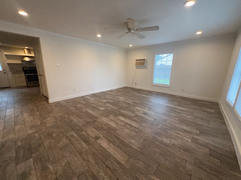1917 Thonig Road Houston, TX 77055 - Photo 3 of 14 an empty room with wooden floor and windows