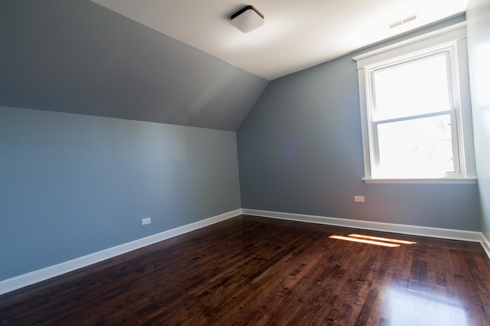 6519 28th Street Berwyn, IL 60402 - Photo 16 of 28 an empty room with wooden floor and windows