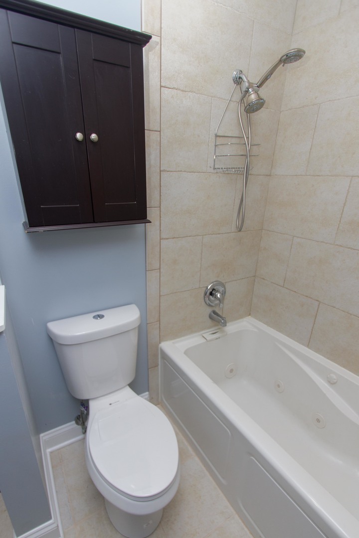 6519 28th Street Berwyn, IL 60402 - Photo 18 of 28 a white toilet sitting next to a bathtub