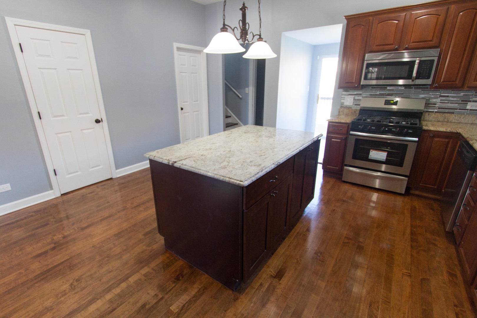 6519 28th Street Berwyn, IL 60402 - Photo 8 of 28 a kitchen with stainless steel appliances granite countertop a stove a sink and a refrigerator