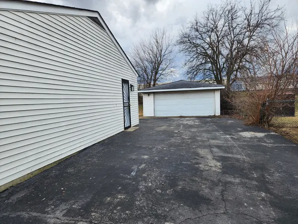 a view of a house with a yard and garage