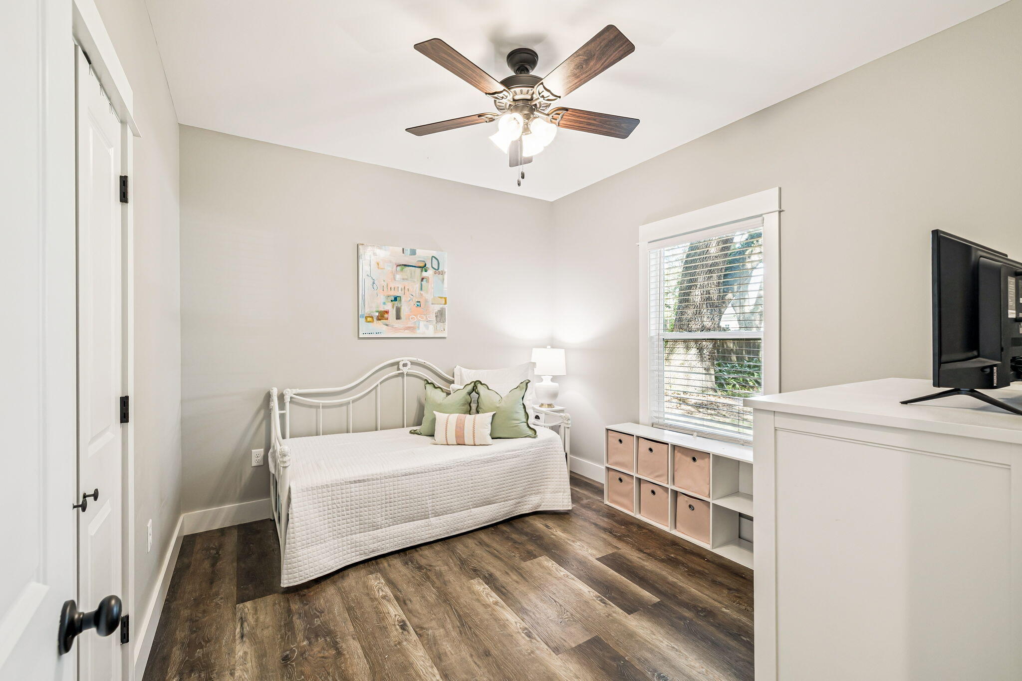 82 Live Oak Street Freeport, FL 32439 - Photo 12 of 22 a bedroom with a bed and a flat tv screen on dresser