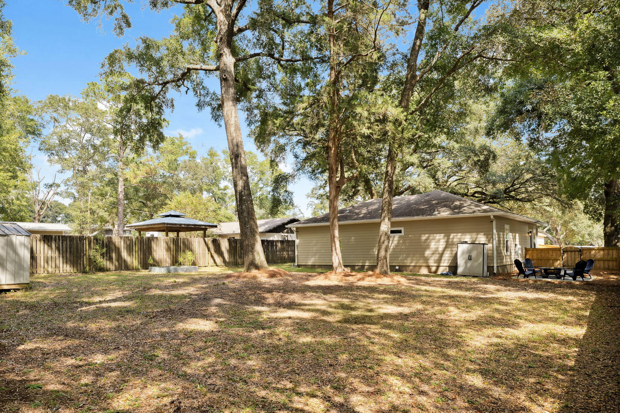 82 Live Oak Street Freeport, FL 32439 - Photo 19 of 22 a front view of a building with large trees