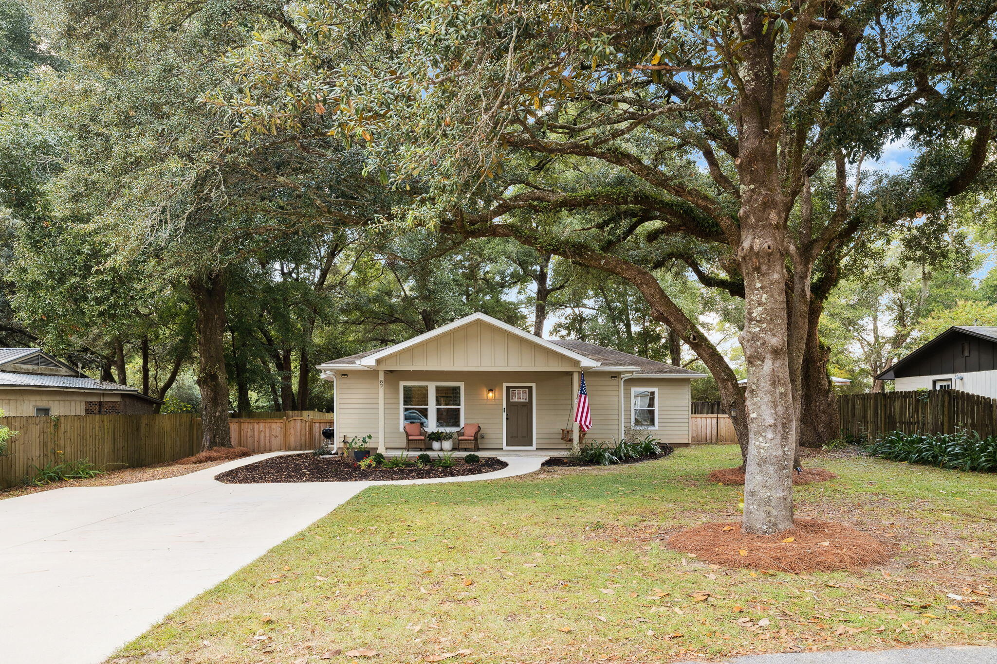 82 Live Oak Street Freeport, FL 32439 - Photo 20 of 22 a front view of a house with yard porch and tree
