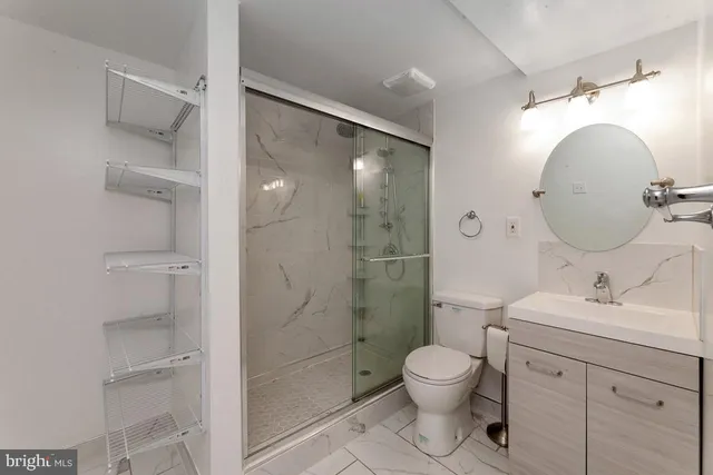a bathroom with a toilet sink and shower