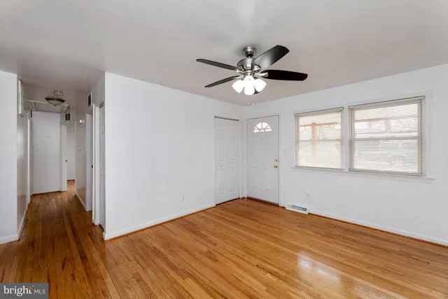 wooden floor in an empty room with a window
