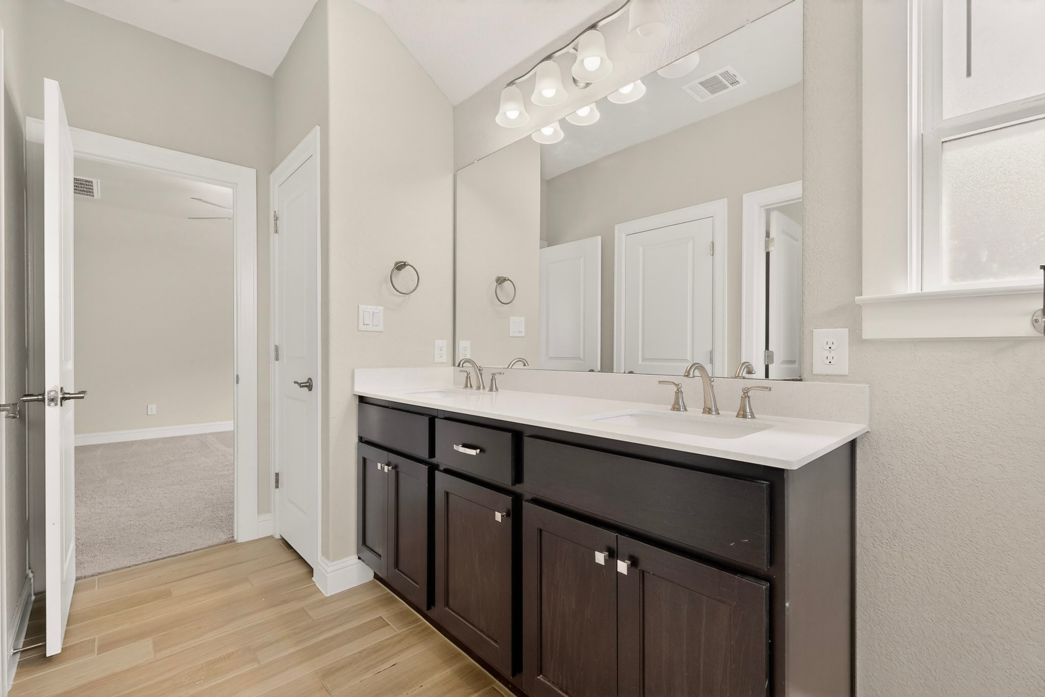 2605 Sam Bass Road, Unit 9 Round Rock, TX 78681 - Photo 28 of 38 Double vanity with sleek dark cabinetry and expansive mirror offers convenience.