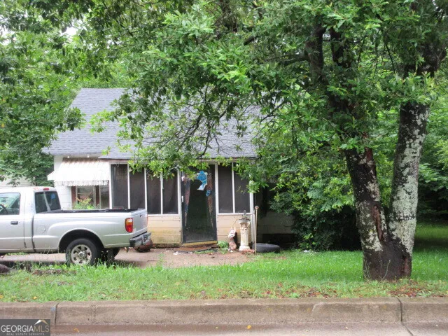 a view of a house with a yard and garage