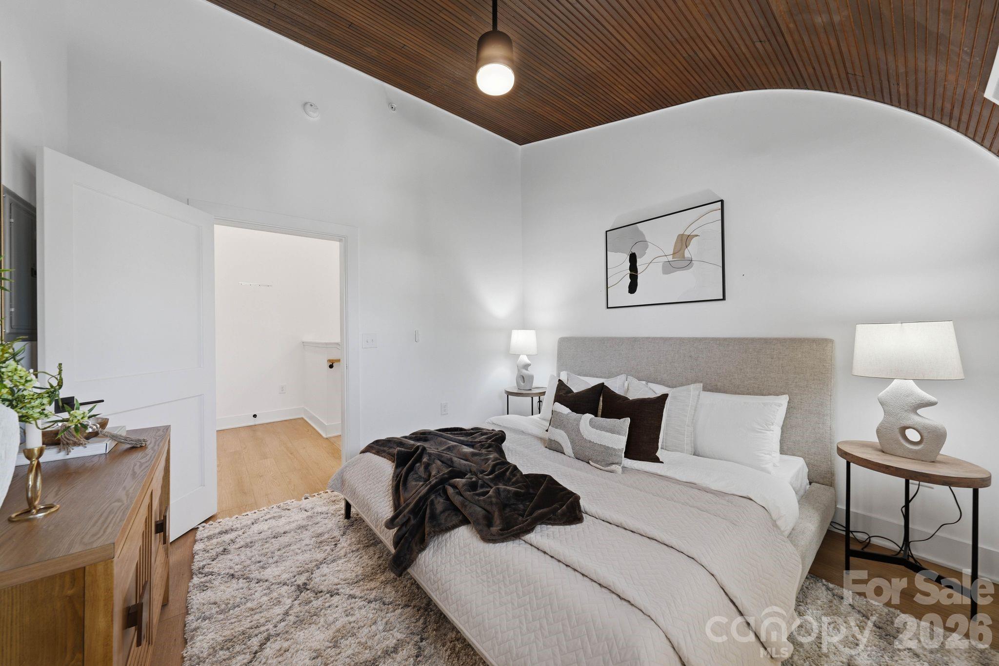 201 Grandin Road, Unit 9 Charlotte, NC 28208 - Photo 22 of 43 a bedroom with a bed and a potted plant