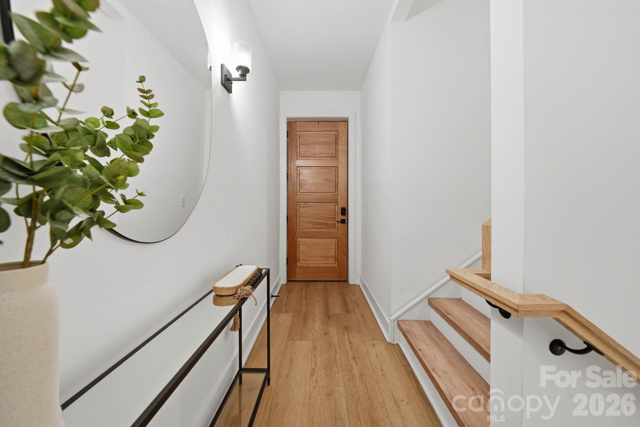 201 Grandin Road, Unit 9 Charlotte, NC 28208 - Photo 23 of 43 a view of a hallway with wooden floor and stairs