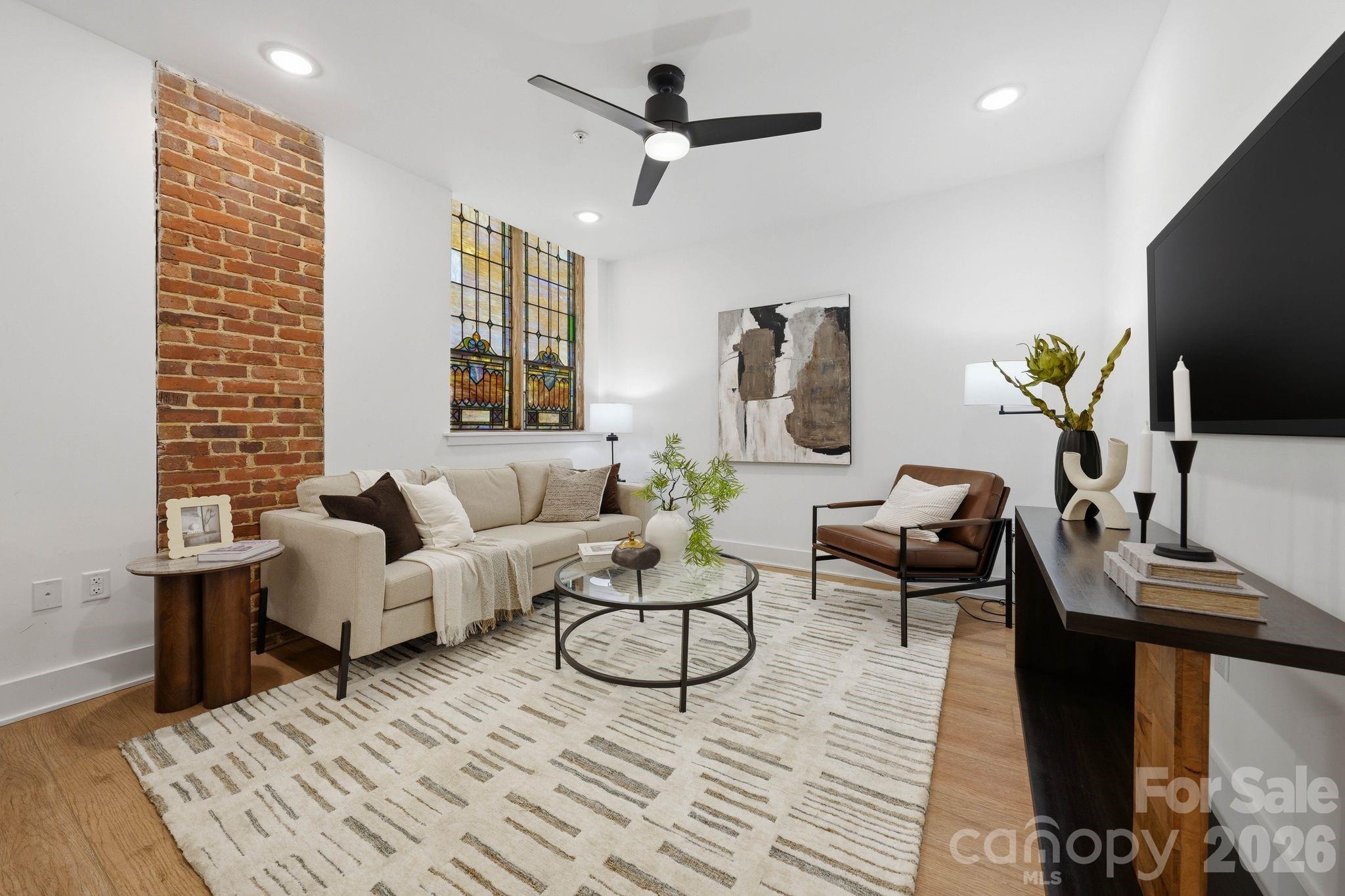 201 Grandin Road, Unit 9 Charlotte, NC 28208 - Photo 7 of 43 a living room with furniture a flat screen tv and a table