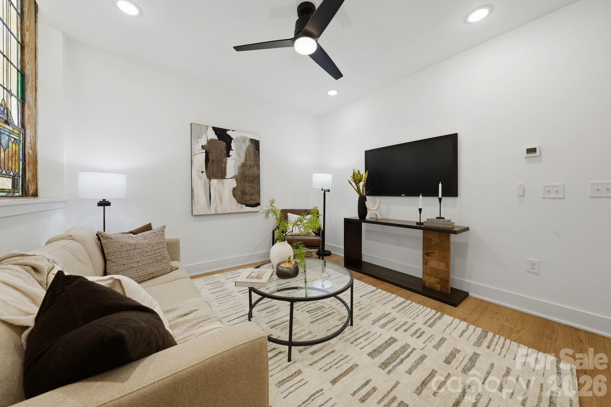 201 Grandin Road, Unit 9 Charlotte, NC 28208 - Photo 8 of 43 a living room with furniture and a flat screen tv