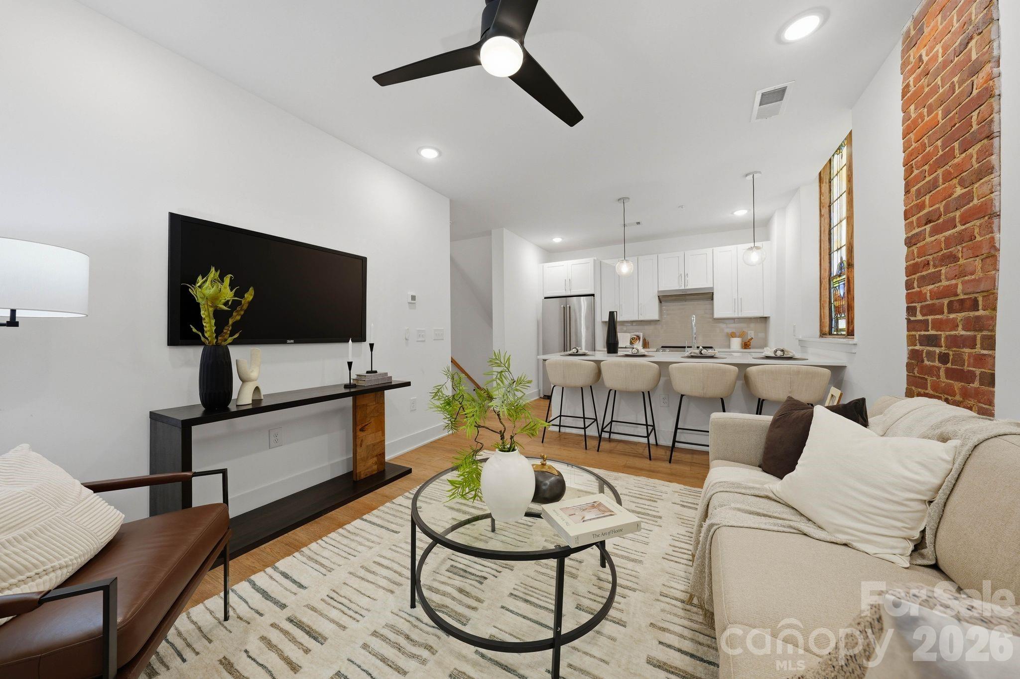 201 Grandin Road, Unit 9 Charlotte, NC 28208 - Photo 9 of 43 a living room with furniture and a flat screen tv
