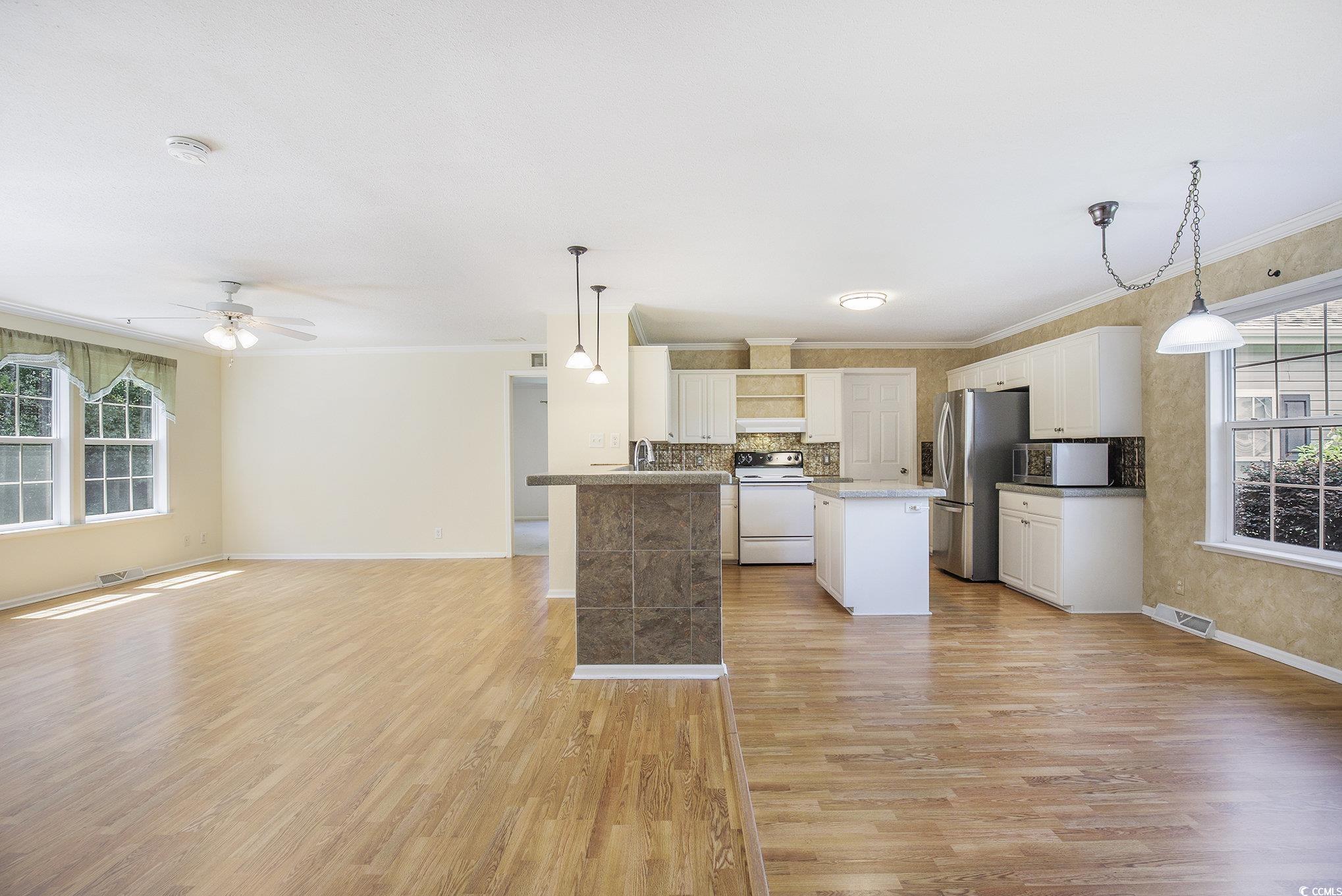 237 Wellspring Drive Conway, SC 29526 - Photo 11 of 33 Kitchen featuring open shelves, stainless steel appliances, a center island, white cabinetry, and tasteful backsplash
