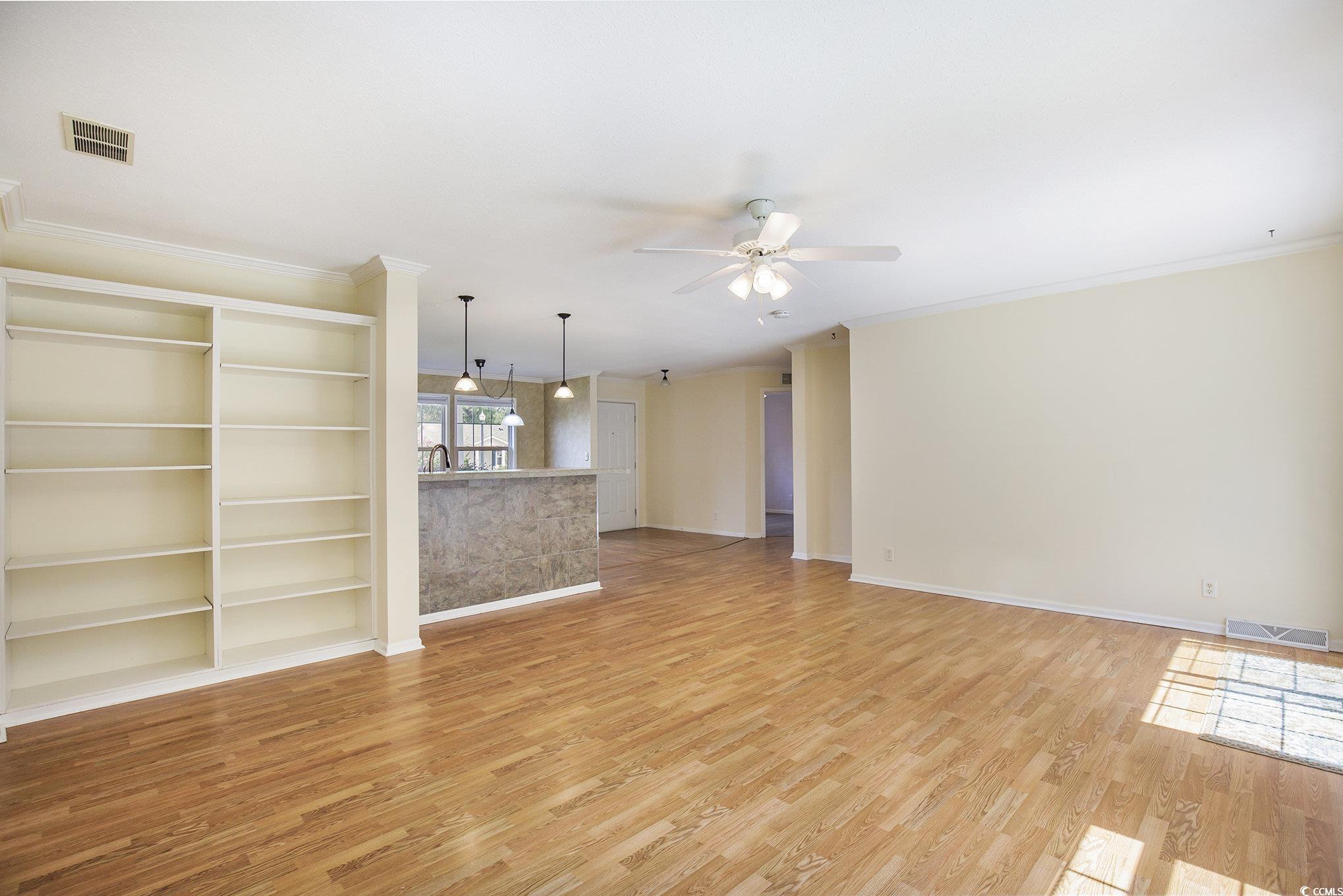 237 Wellspring Drive Conway, SC 29526 - Photo 12 of 33 Unfurnished room with light wood-style floors, crown molding, and ceiling fan