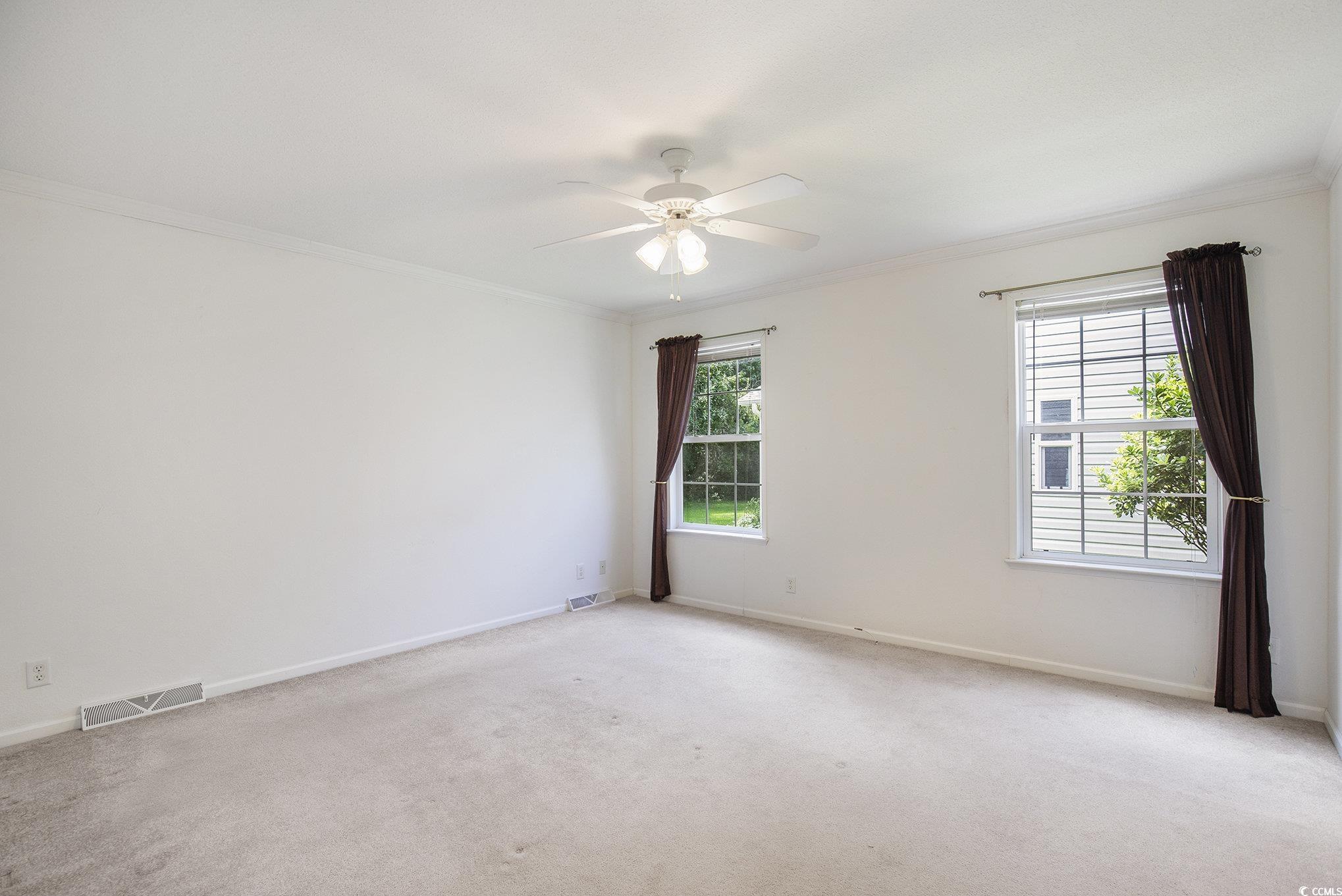 237 Wellspring Drive Conway, SC 29526 - Photo 16 of 33 Unfurnished bedroom with light colored carpet, ornamental molding, a ceiling fan, and ensuite bath