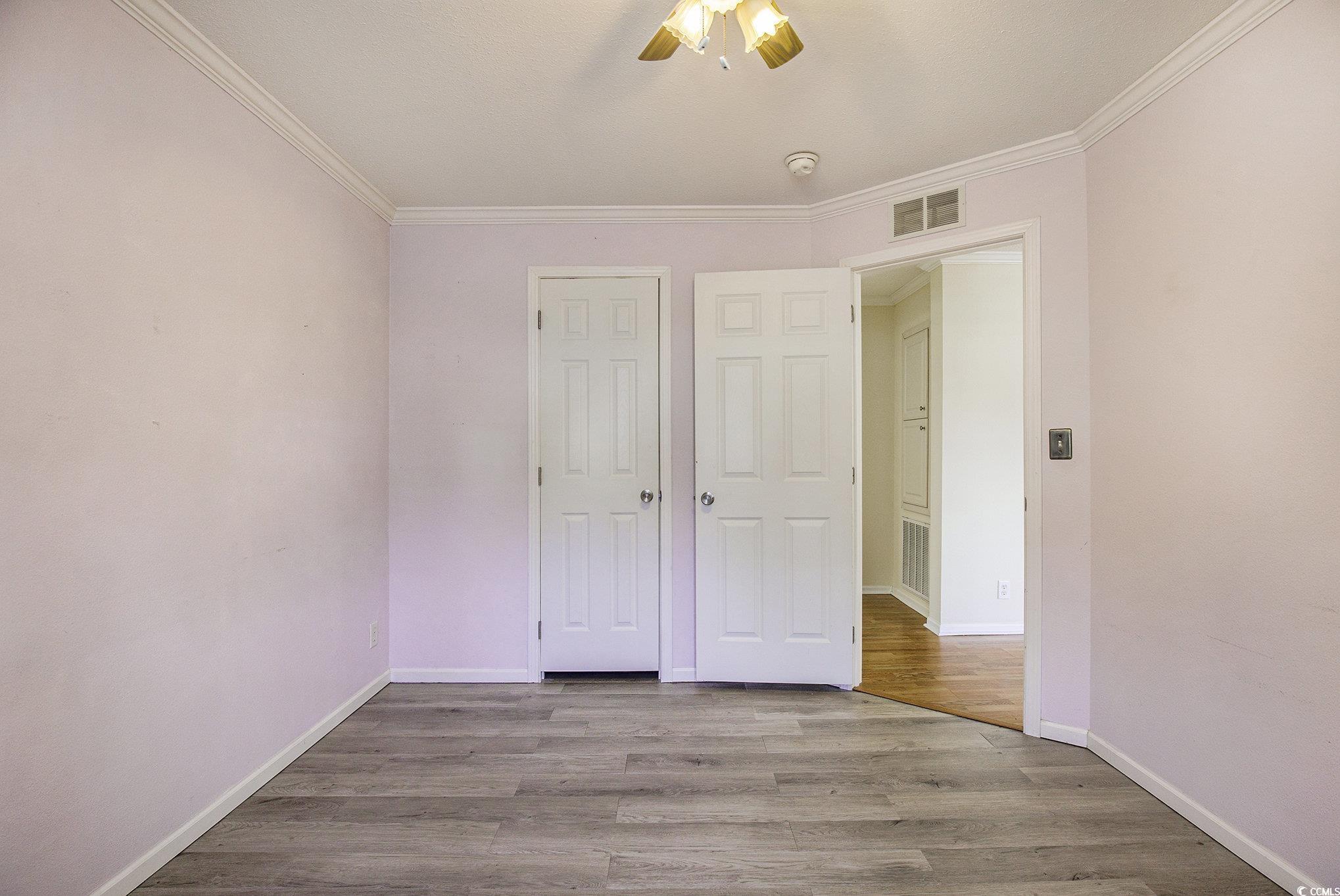 237 Wellspring Drive Conway, SC 29526 - Photo 19 of 33 Unfurnished room with crown molding, light wood finished floors, and ceiling fan